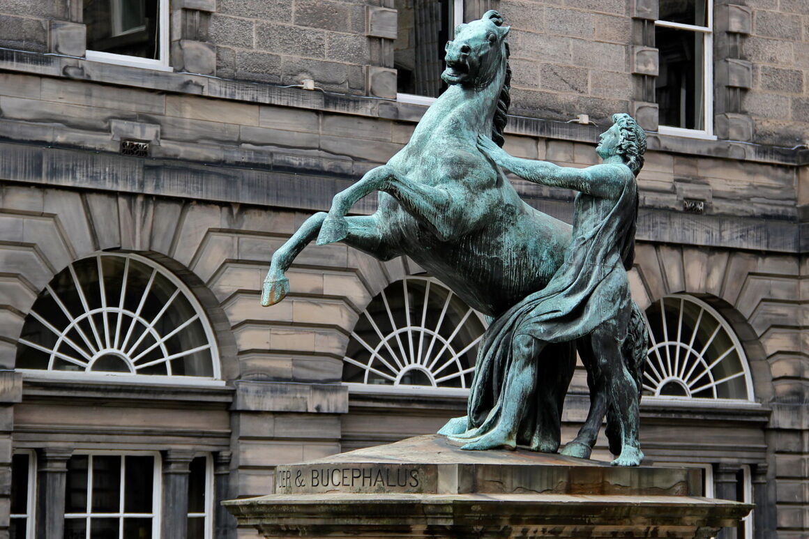 A bronze statue of a man and a rearing horse
